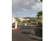 Gated community entrance with desert landscaping, palm trees, and mountain views in a suburban setting at 75 N Valle Verde Dr # 621, Henderson, NV 89074