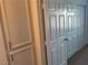 Spacious hallway with built-in storage cabinets and a large closet with white doors, maximizing storage solutions at 75 N Valle Verde Dr # 621, Henderson, NV 89074