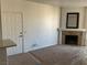 Spacious living room with plush carpeting, fireplace, and a front door for easy access at 75 N Valle Verde Dr # 621, Henderson, NV 89074