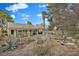Spacious backyard featuring desert landscaping, mature trees, a covered patio and other amenities at 7713 Shore Haven Dr, Las Vegas, NV 89128