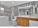 Bright bathroom featuring double sinks, tile flooring, a large mirror and modern lighting at 7713 Shore Haven Dr, Las Vegas, NV 89128