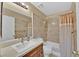 Well-lit bathroom with a shower-tub combination, a single sink vanity, and neutral tile at 7713 Shore Haven Dr, Las Vegas, NV 89128