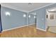 Bright bedroom featuring wood-look flooring, sliding mirror closet, and sconce lighting at 7713 Shore Haven Dr, Las Vegas, NV 89128