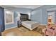 Cozy bedroom featuring natural light and a decorative headboard and a light blue painted walls at 7713 Shore Haven Dr, Las Vegas, NV 89128