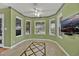 Bright dining room featuring a bay window, tiled floor, ceiling fan, and a wall-mounted TV at 7713 Shore Haven Dr, Las Vegas, NV 89128