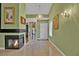 Inviting entryway with a fireplace, elegant chandelier, and framed art pieces on green walls at 7713 Shore Haven Dr, Las Vegas, NV 89128