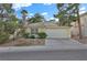 Charming one-story home with desert landscaping and an attached two-car garage with a paved driveway at 7713 Shore Haven Dr, Las Vegas, NV 89128