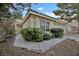 Well-maintained home with a tiled roof and landscaped front yard featuring mature green bushes at 7713 Shore Haven Dr, Las Vegas, NV 89128