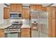 Updated kitchen featuring stainless steel appliances, gas range, quartz countertops and shaker style cabinets at 7713 Shore Haven Dr, Las Vegas, NV 89128