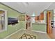 Open floor plan featuring a kitchen with wooden cabinets flowing into a dining area with tiled floors at 7713 Shore Haven Dr, Las Vegas, NV 89128