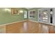 Bright living room features wood-look flooring, windows with blinds, and French doors to the outside at 7713 Shore Haven Dr, Las Vegas, NV 89128