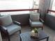 Relaxing balcony features two chairs and a table with plants at 8600 W Charleston Blvd # 2086, Las Vegas, NV 89117