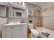 Well-lit bathroom boasts a bathtub and shower, vanity with storage, and tiled walls at 8600 W Charleston Blvd # 2086, Las Vegas, NV 89117