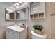 Well-lit bathroom features a vanity with storage and a decorative wall cabinet at 8600 W Charleston Blvd # 2086, Las Vegas, NV 89117