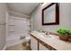 Bathroom featuring a tub and shower combo, a vanity with ample storage space, and a large mirror at 8600 W Charleston Blvd # 2086, Las Vegas, NV 89117