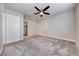 Neutral bedroom features a ceiling fan, plush carpet, and a closet at 8600 W Charleston Blvd # 2086, Las Vegas, NV 89117