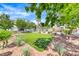 Community courtyard featuring a manicured lawn, desert landscaping, and mature shade trees at 8600 W Charleston Blvd # 2086, Las Vegas, NV 89117