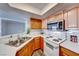 Well-lit kitchen features stainless steel appliances, light wood cabinets, and stone countertops at 8600 W Charleston Blvd # 2086, Las Vegas, NV 89117