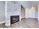 Bright, empty living room features a decorative stone fireplace and wood flooring at 8600 W Charleston Blvd # 2086, Las Vegas, NV 89117