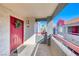 Cozy patio with a vibrant red door, decorative wreath, and a view of the surrounding neighborhood at 8600 W Charleston Blvd # 2086, Las Vegas, NV 89117