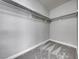 Walk-in closet with neutral paint and carpet and clothes hanging from the racks at 8600 W Charleston Blvd # 2086, Las Vegas, NV 89117