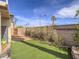 Low-maintenance backyard with artificial turf, a block wall and desert landscaping at 9211 Wittig Ave, Las Vegas, NV 89149
