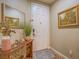 Inviting entryway featuring a console table with a mirror, artwork, and tile flooring at 9211 Wittig Ave, Las Vegas, NV 89149
