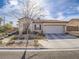 Charming single-story home with a two-car garage, low maintenance landscaping, and a tile roof at 9211 Wittig Ave, Las Vegas, NV 89149