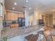 Bright kitchen with granite counters and stainless appliances, with views into the living spaces at 9211 Wittig Ave, Las Vegas, NV 89149