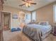 Comfortable main bedroom with carpeted floors, ceiling fan, and ensuite bathroom at 9211 Wittig Ave, Las Vegas, NV 89149