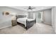 Spacious main bedroom featuring plush carpeting, a ceiling fan, and a large window for natural light at 10158 Phelps Lake Ct, Las Vegas, NV 89148