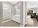 Modern bathroom featuring a glass-enclosed shower, sleek vanity, and access to outdoor patio at 12119 Castilla Rain Ave, Las Vegas, NV 89138