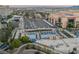 Elevated view highlighting the large pool area, parking, and lush landscaping, with city views in the background at 145 E Harmon Ave # 1202, Las Vegas, NV 89109