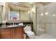 Elegant bathroom with a large mirror, glass shower, and modern fixtures at 145 E Harmon Ave # 1202, Las Vegas, NV 89109
