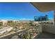 Balcony view of the city, pool area, and palm trees at 145 E Harmon Ave # 1202, Las Vegas, NV 89109