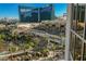 Balcony view of the city, pool area, and palm trees at 145 E Harmon Ave # 1202, Las Vegas, NV 89109