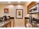 Modern kitchen features dark countertops, stainless steel appliances, and wooden cabinetry at 145 E Harmon Ave # 1202, Las Vegas, NV 89109