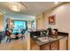 Open kitchen with dark countertops, stainless steel appliances, and views of the living area at 145 E Harmon Ave # 1202, Las Vegas, NV 89109