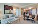 Open-concept living area with stylish seating, a modern kitchen, and elegant dining space at 145 E Harmon Ave # 1202, Las Vegas, NV 89109