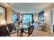 Comfortable living room with a dining table, comfortable seating, built in cabinets and large windows at 145 E Harmon Ave # 1202, Las Vegas, NV 89109