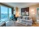 Bright living room with a comfortable couch, stylish decor, and a large window with beautiful views at 145 E Harmon Ave # 1202, Las Vegas, NV 89109