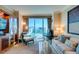 Sunny living room features modern seating, a built-in entertainment center, and views from the window at 145 E Harmon Ave # 1202, Las Vegas, NV 89109
