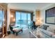 Bright and comfortable living room features contemporary seating, built-ins, and large window with a view at 145 E Harmon Ave # 1202, Las Vegas, NV 89109