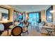 Living room features a table with chairs, built in cabinets and comfortable seating and large windows at 145 E Harmon Ave # 1202, Las Vegas, NV 89109