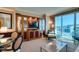 Bright living room with a built-in entertainment center, comfortable seating, and city views at 145 E Harmon Ave # 1202, Las Vegas, NV 89109