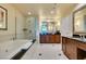 Luxurious bathroom with a soaking tub, glass shower, and modern double sink vanity at 145 E Harmon Ave # 1202, Las Vegas, NV 89109