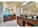 Bright bathroom featuring double sink vanity, large mirrors, and glass shower at 145 E Harmon Ave # 1202, Las Vegas, NV 89109