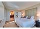 Bright bedroom featuring a large bed with decorative pillows and an ensuite bathroom at 145 E Harmon Ave # 1202, Las Vegas, NV 89109