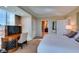 Comfortable bedroom featuring a large window, desk, and an ensuite bathroom at 145 E Harmon Ave # 1202, Las Vegas, NV 89109