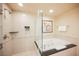 Bright bathroom features a soaking tub with shower and sleek black countertop at 145 E Harmon Ave # 2603, Las Vegas, NV 89109